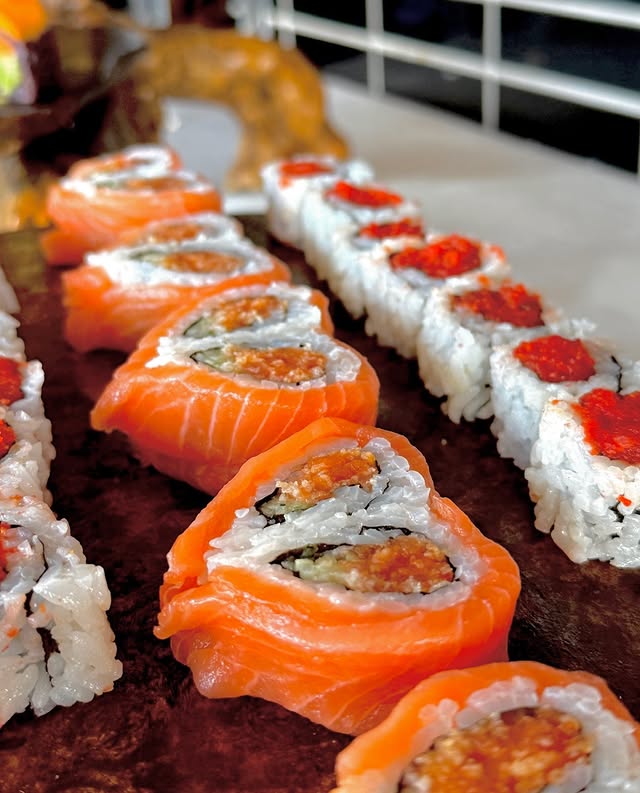 Closeup of salmon roll with fresh avocado at a wedding sushi catering event in New York