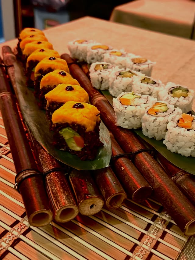 Assorted sushi rolls and nigiri arranged on a bamboo platter for NYC catering service