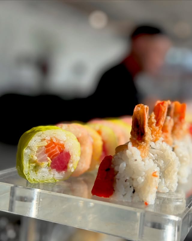 Private sushi chef preparing artisan rainbow rolls at an exclusive NYC event